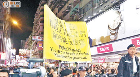 警方舉黃旗驅趕市民離開。