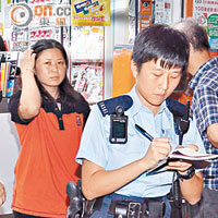 遇襲女店員向警員講述經過。（張曉楠攝）