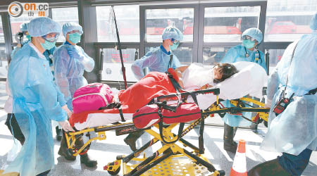 醫護人員穿上防護裝備將感染諾如病毒的病人送院。