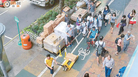 除了貨物阻塞外，單車徑上亦有多名行人，令單車難以駛過。（讀者提供）