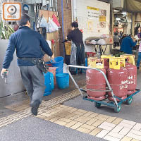 記者巡查期間遇到有人以手推車運送多罐石油氣到場替換。