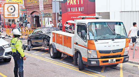 有長時間違泊的私家車，被警方召來拖車拖走。（黃偉邦攝）