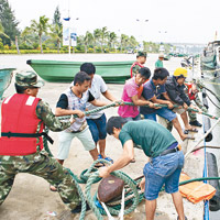 海南全省昨停工停課，瓊州海峽全線停航，邊防官兵協助漁民加固漁船。