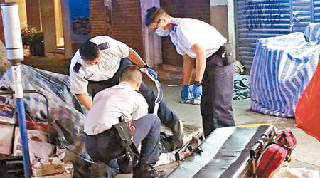 墮樓老翁倒臥生果店旁，救護員到場搶救。（互聯網圖片）