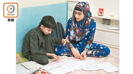 Iqra（右） 和就讀主流小學二年級的弟弟Hassan溫習中文課文，未能讀出小二的部分生字。