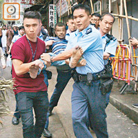 被捕巴漢由五名警員合力抬走。