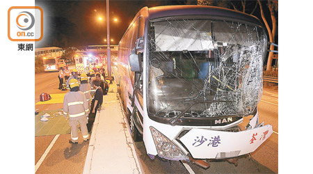 直通巴車頭損毀嚴重，在快線石壆旁停下。（梁國雄攝）