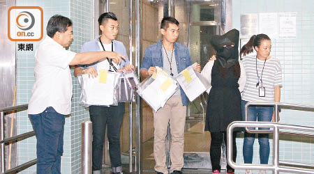警方押女疑犯回富泰邨寓所搜證，檢走一批證物。（文健雄攝）