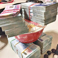 疑犯將大疊鈔票放在杯麵蓋上炫耀。（互聯網圖片）