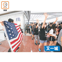 又一城的示威期間有人揮舞美國國旗。