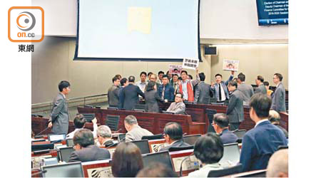 朱凱廸舉起「警暴未除，仲點開會」標語，被要求離開會議室。（溫國佳攝）