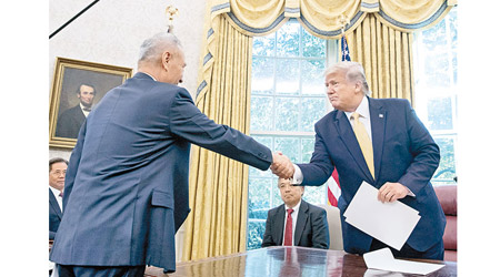 劉鶴（左）轉交習近平的信件後，與特朗普（右）握手。（美聯社圖片）