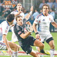 新西蘭（黑衫）球員遭３名法國守衞夾擊，仍能成功達陣。