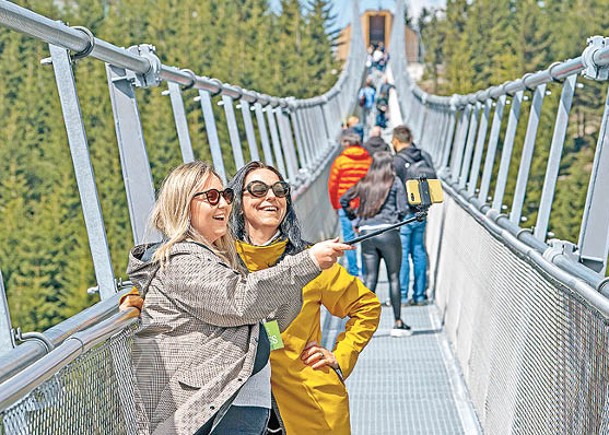 遊客踏上吊橋拍照留念。