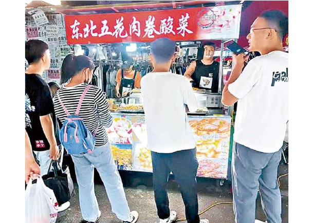 小宋擺攤售賣東北五花肉卷酸菜。
