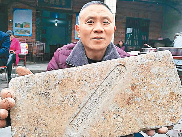 十字卡村村民拿着蘇符的墓磚。