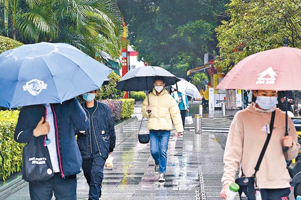 廣東：廣州市民撐傘出行。（中新社圖片）
