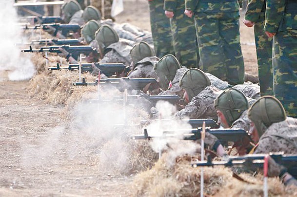 北韓人民軍空降兵持槍，向模擬敵方目標開火。