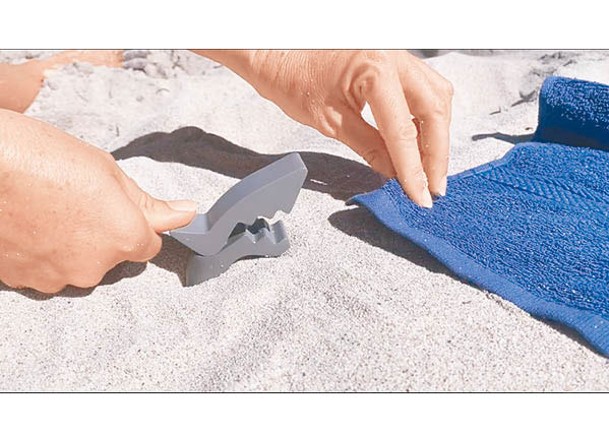 只需夾起毛巾角落並插入沙中，即可牢牢固定毛巾。
