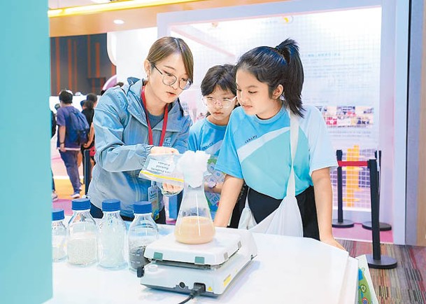 學生參觀浸大展館，了解利用細菌將廢棄食用油和其他有機殘餘物轉化為環保生物塑膠。