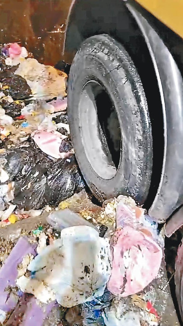 由於石壆損毀，垃圾車後轆易跌落垃圾槽。