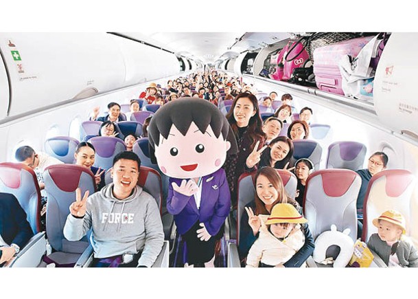 小丸子在香港快運航空首航上與旅客合照。