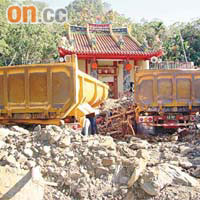 桃源鄉一間寺廟，遭兩部被泥石流沖來的卡車擋住門口。	（本報高雄傳真）