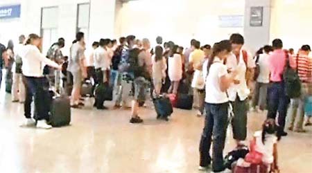 大批旅客在上海虹橋站詢問列車情況。	（電視畫面）