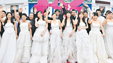 杭州拱墅區環衞所在婦女節前夕，為十二對從外地來杭的清潔工人夫婦補拍婚紗照。（中新社圖片）