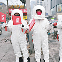 太原<BR>山西太原四名男子以太空人裝扮在街頭派發口罩。