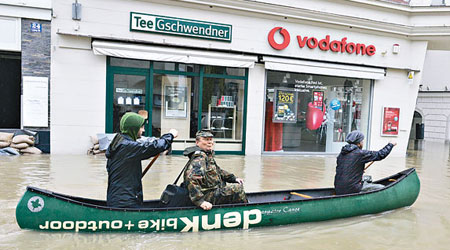 德國巴伐利亞州的民眾要乘小艇撤離被淹浸的街道。