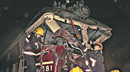哈爾濱鐵路列車追撞貨車事故中，消防員正在進行救援。（中新社圖片）