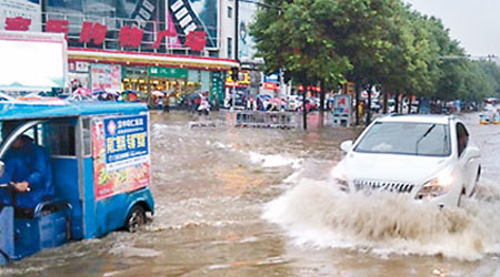 陝西漢中街道水浸，車輛涉水而行。（互聯網圖片）