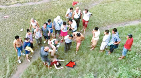 大批途人圍觀被救上岸的女子（箭嘴示）。（互聯網圖片）