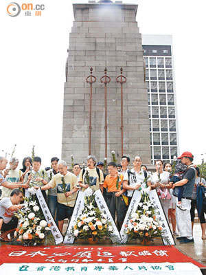香港示威人士遊行至中環和平紀念碑，向抗日烈士獻花。（蘇文傑攝）