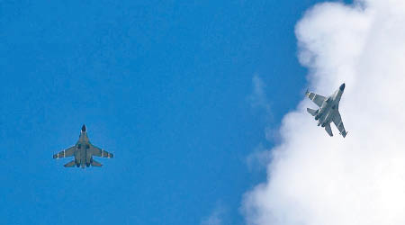 軍報刊登照片顯示，殲11B戰機掛導彈飛赴南海。（互聯網圖片）