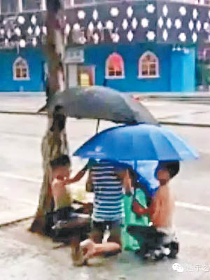 男童獲好友到場舉傘支持。