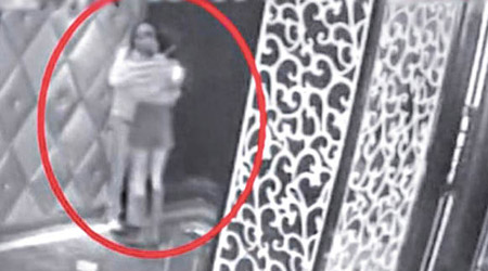 監控鏡頭拍到周新勝與一名女郎疑似擁吻。（電視畫面）