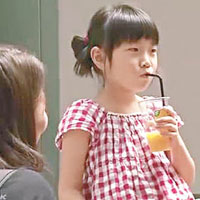 女童急不及待一嘗水龍頭蜜柑汁的滋味。（電視畫面）