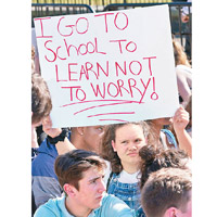 有學生手持「返學是為了學習，而非擔心」的紙牌。