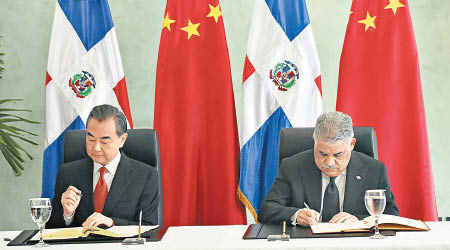 王毅（左）與多明尼加外長（右）瓦爾加斯簽署雙邊協議。（美聯社圖片）