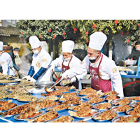 四川眉山有過千農民工齊聚一堂食團年飯，大廚們烹煮糖醋魚。（中新社圖片）