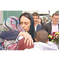 披黑頭巾的新西蘭總理阿德恩擁抱安慰回教徒。（美聯社圖片）