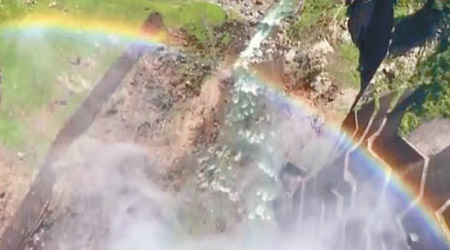 洪水在陽光照射下出現彩虹。（電視畫面）