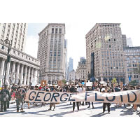 紐約州：紐約市民眾舉起橫額遊行。（中新社圖片）