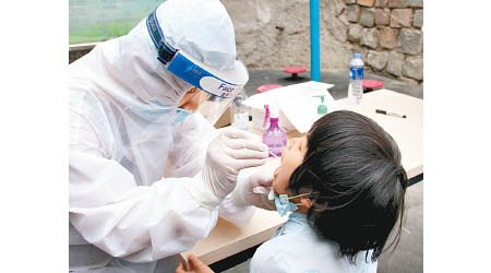 新疆烏魯木齊醫護人員採集市民的唾液樣本。（中新社圖片）
