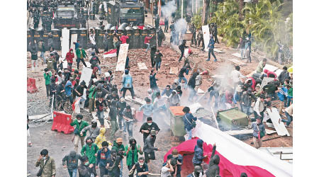 雅加達警方向示威學生發射催淚彈。（美聯社圖片）