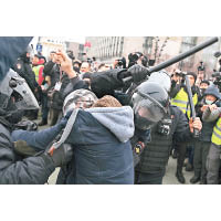 防暴警手持警棍揮打示威群眾。（美聯社圖片）