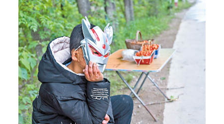 君宇會幫家人在馬路旁賣車厘子。