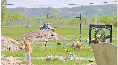 學校遺址附近發現多個無名墓碑。（電視畫面）